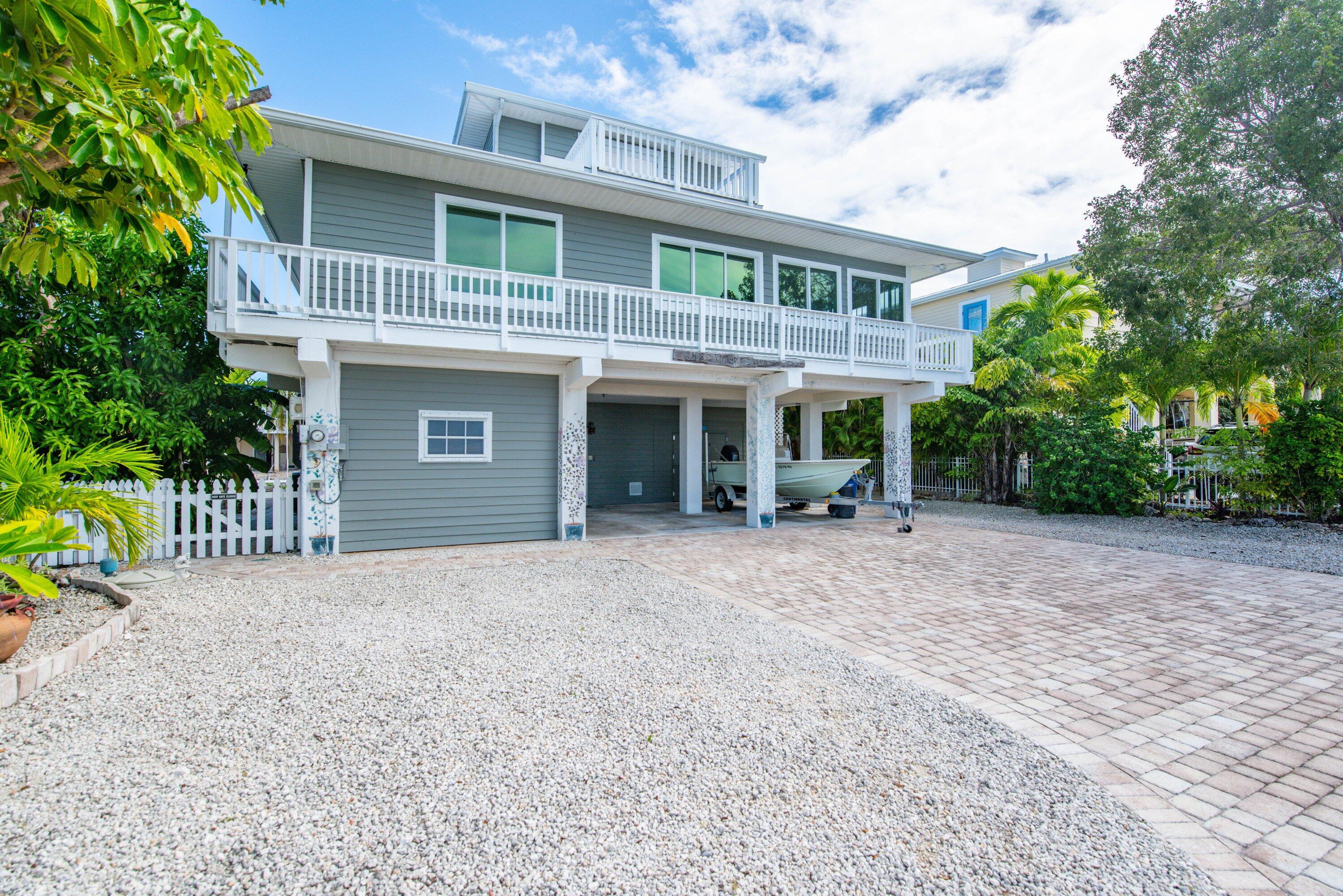 643 Indies Road Summerland Key, FL 33042 - Photo 34 of 50 a view of a house with a yard and plants