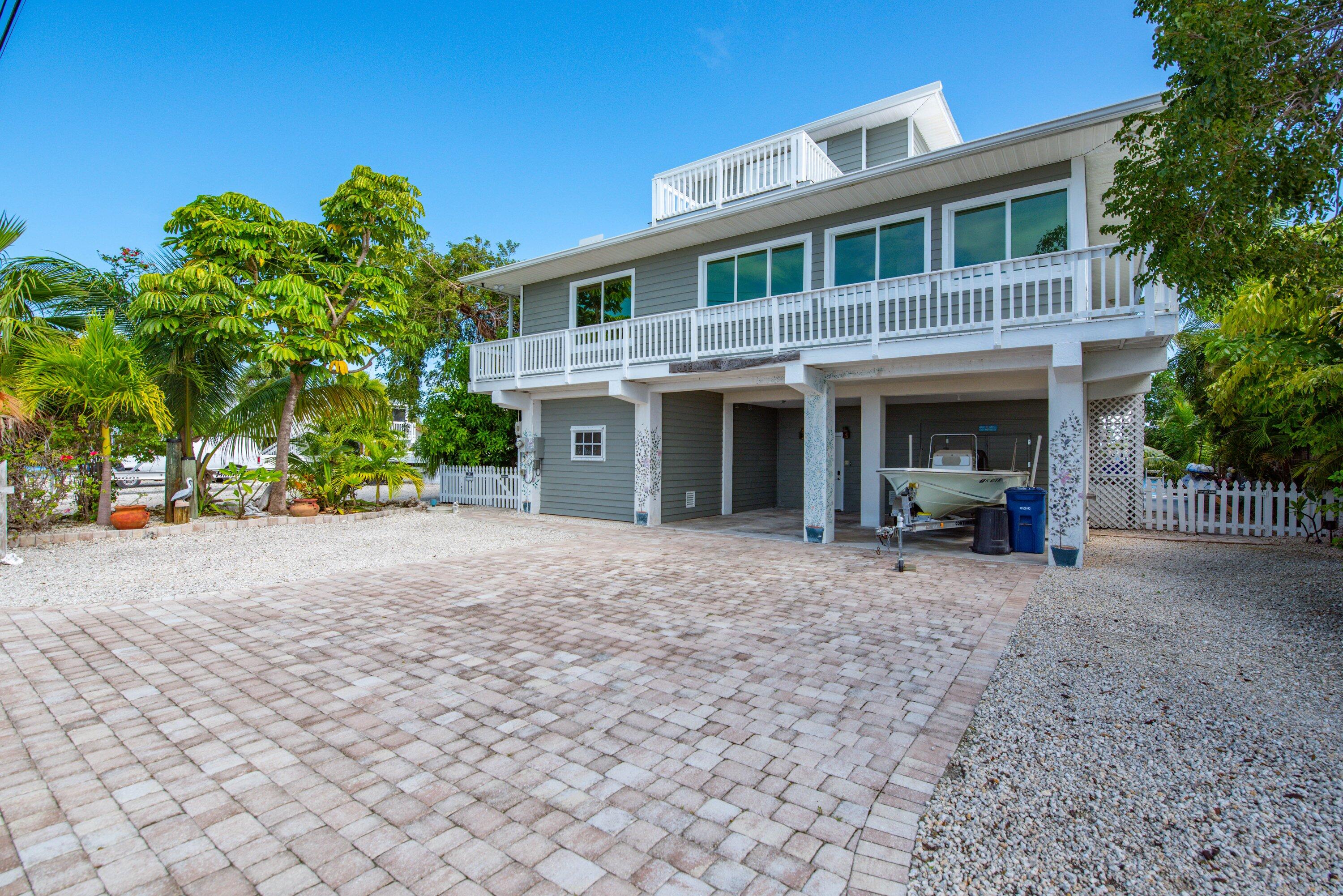 643 Indies Road Summerland Key, FL 33042 - Photo 35 of 50 a front view of a house with a yard and a garage