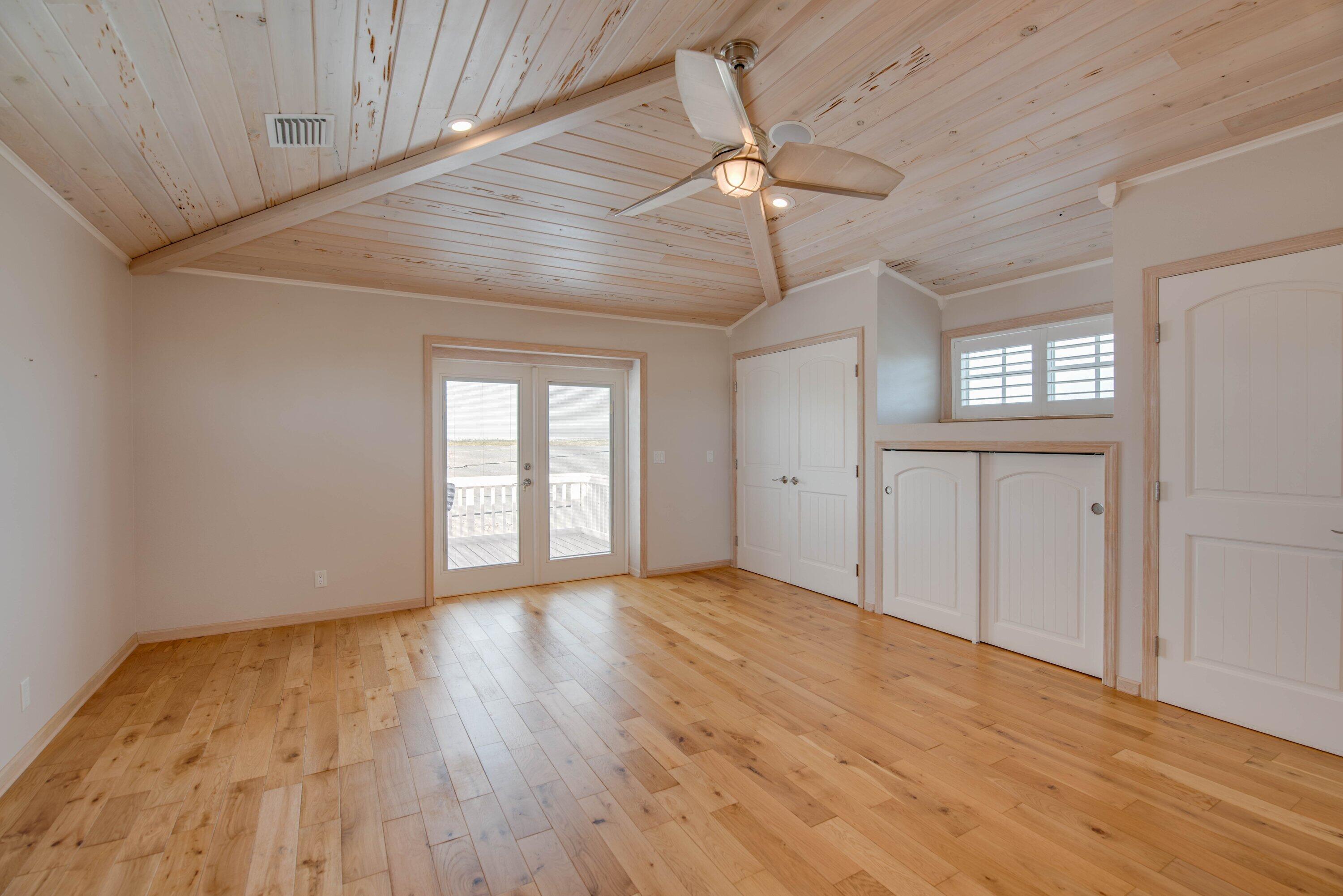 643 Indies Road Summerland Key, FL 33042 - Photo 45 of 50 a view of an empty room with wooden floor and a window