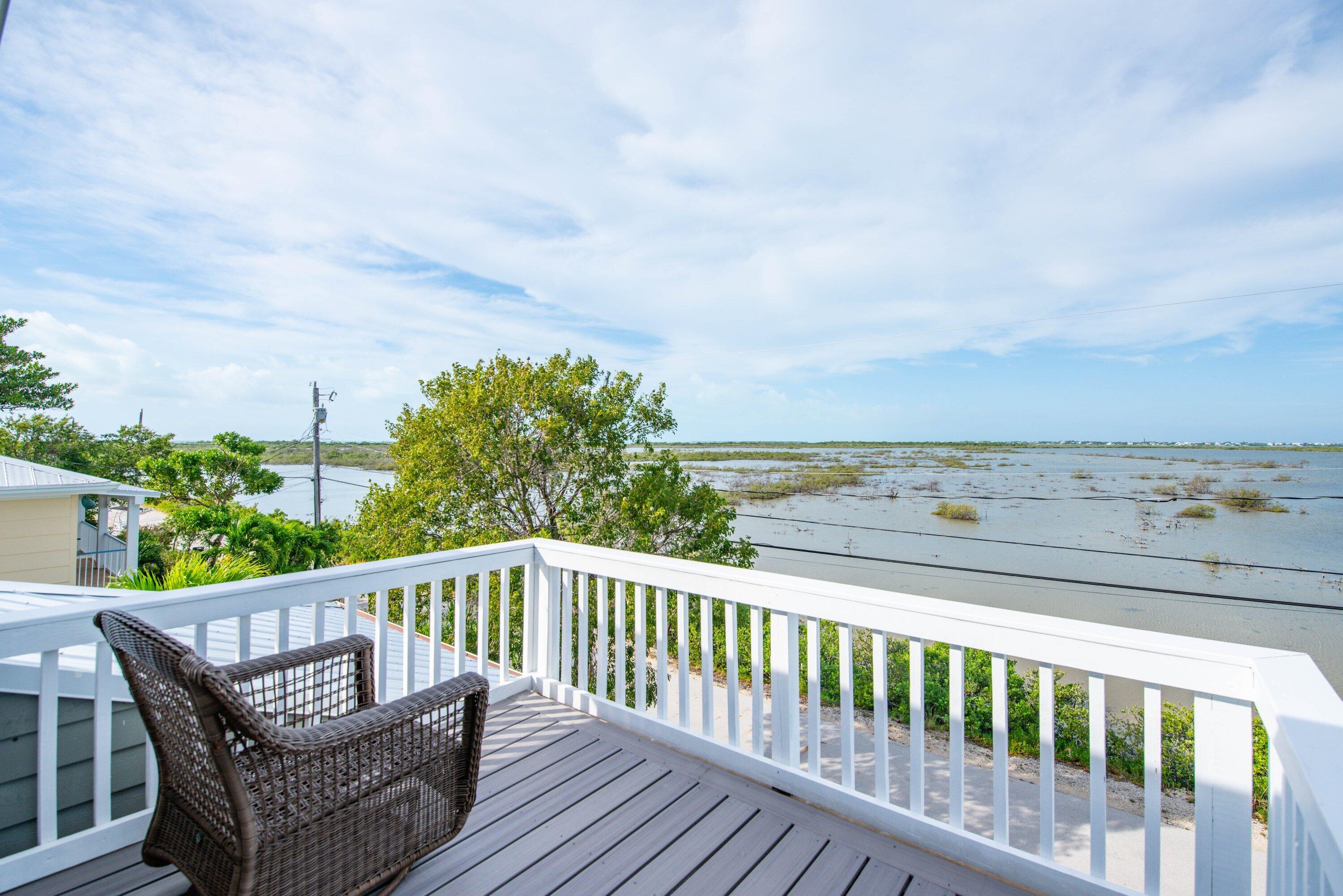 643 Indies Road Summerland Key, FL 33042 - Photo 10 of 50 a view of a balcony with wooden floor and fence
