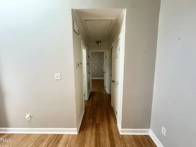 a view of a hallway with a wooden floor