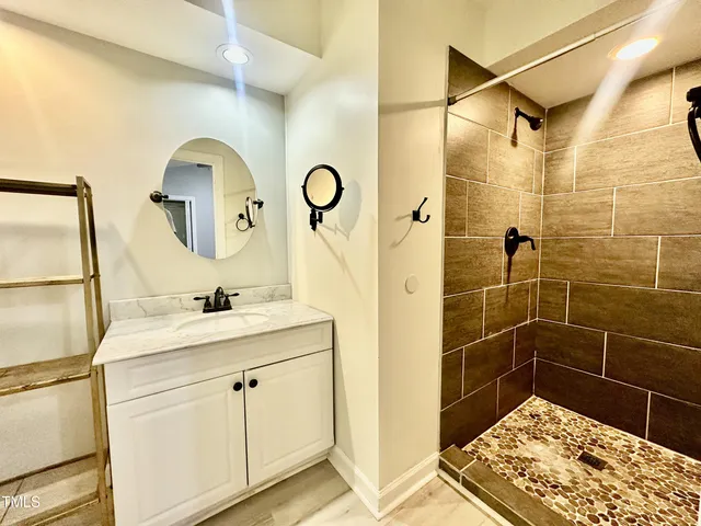 a bathroom with a sink toilet and shower
