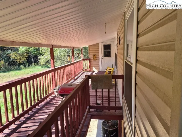 a view of balcony with wooden floor and outdoor seating