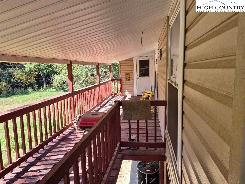 720 Mash Road West Jefferson, NC 28694 - Photo 11 of 31 a view of balcony with wooden floor and outdoor seating