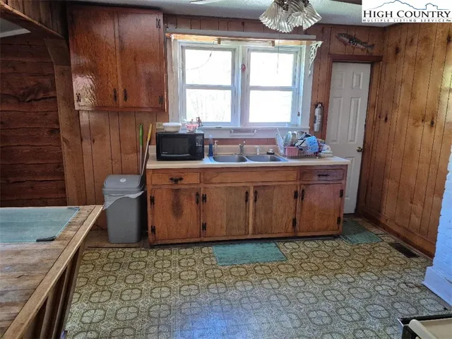 a bathroom with a granite countertop sink a mirror and a bathtub
