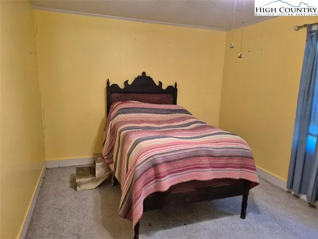 a bedroom with a bed and wall painting