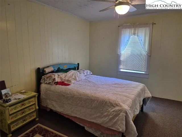 a bedroom with a bed and window