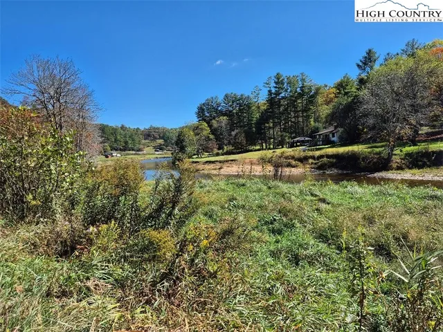 a view of a lake with houses in the back