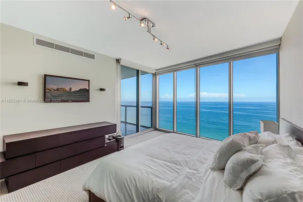 a bedroom with a large bed and a large window