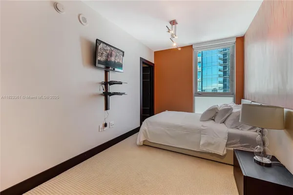 a bedroom with a bed and window