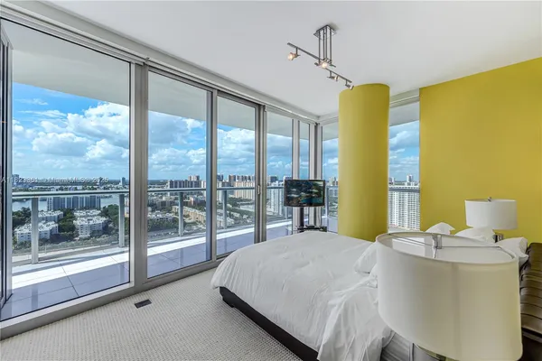 a bed sitting in a bedroom next to a large window