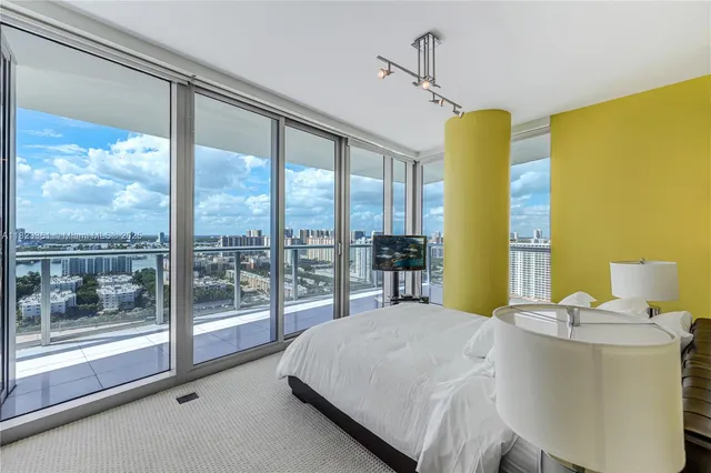 a bed sitting in a bedroom next to a large window
