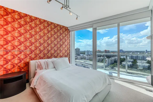 a bedroom with a large bed and a lamp next to a window