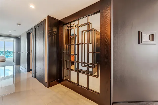 a view of a hallway with wooden floor and furniture