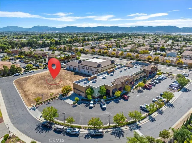 an aerial view of a houses with a swimming pool