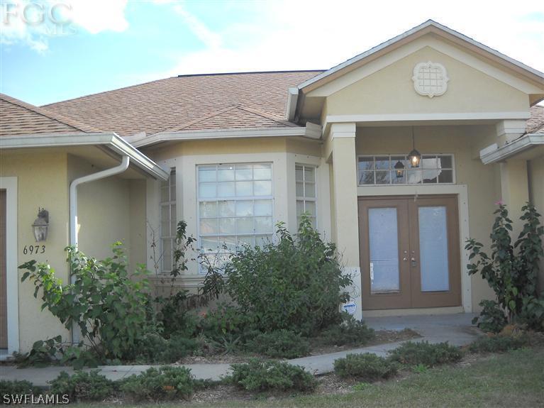 a front view of a house with garden