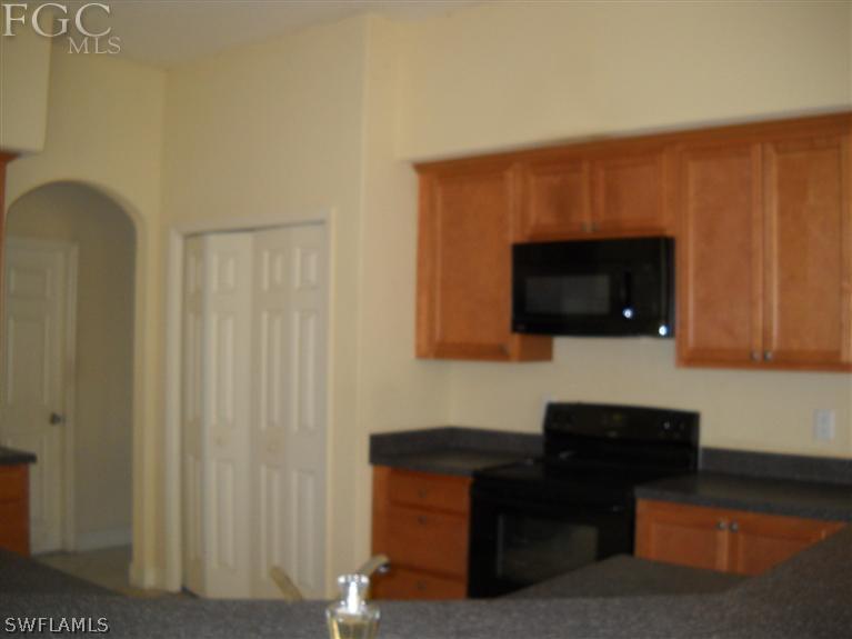 6973 Debrita Road North Port, FL 34291 - Photo 11 of 18 a living room with a couch and a flat screen tv