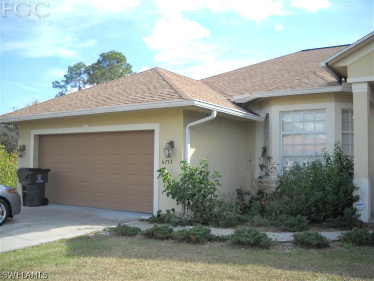 6973 Debrita Road North Port, FL 34291 - Photo 3 of 18 a front view of a house with garden