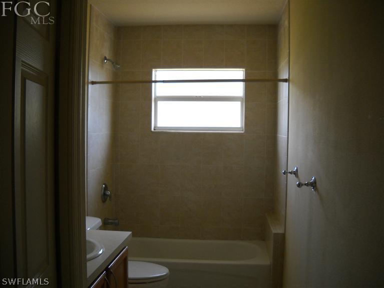 6973 Debrita Road North Port, FL 34291 - Photo 7 of 18 a bathroom with a granite countertop sink toilet and shower