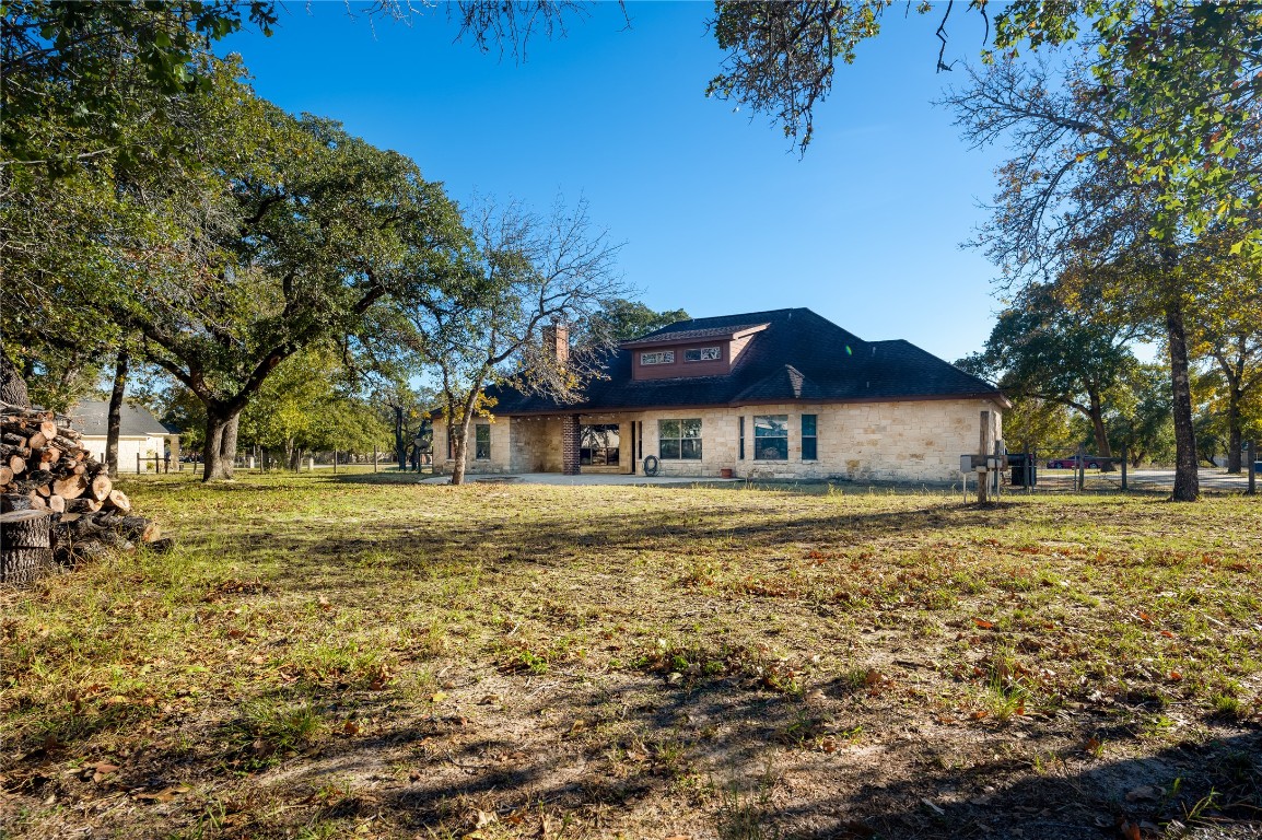 455 Rose Blossom Loop La Vernia, TX 78121 - Photo 21 of 24 a front view of a house with a yard