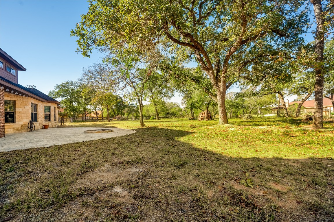 455 Rose Blossom Loop La Vernia, TX 78121 - Photo 22 of 24 a view of yard with swimming pool and trees