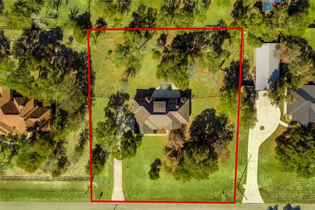 a view of a house with a yard and tree s