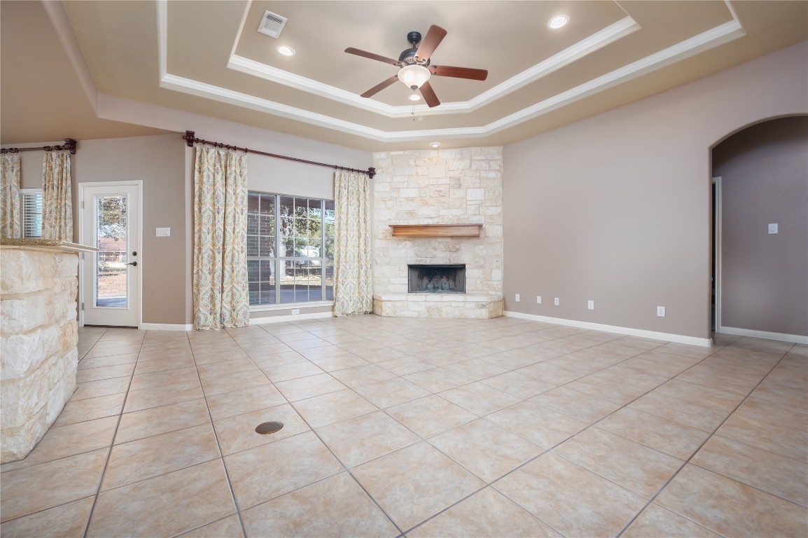 455 Rose Blossom Loop La Vernia, TX 78121 - Photo 9 of 24 a living room with a fireplace furniture a ceiling fan and a rug