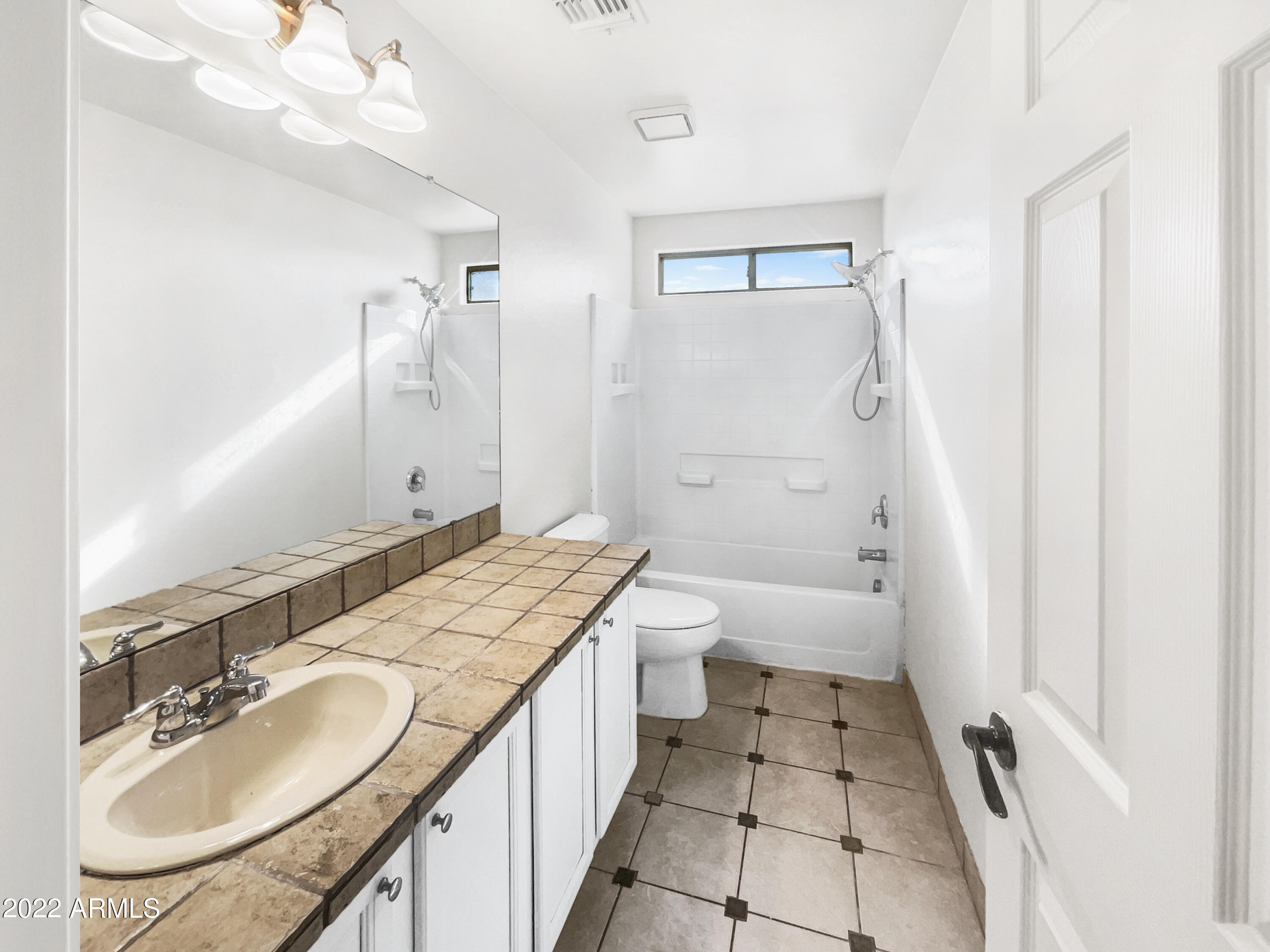 44011 West Cowpath Road Maricopa, AZ 85138 - Photo 12 of 18 a bathroom with a granite countertop sink a mirror and a bathtub