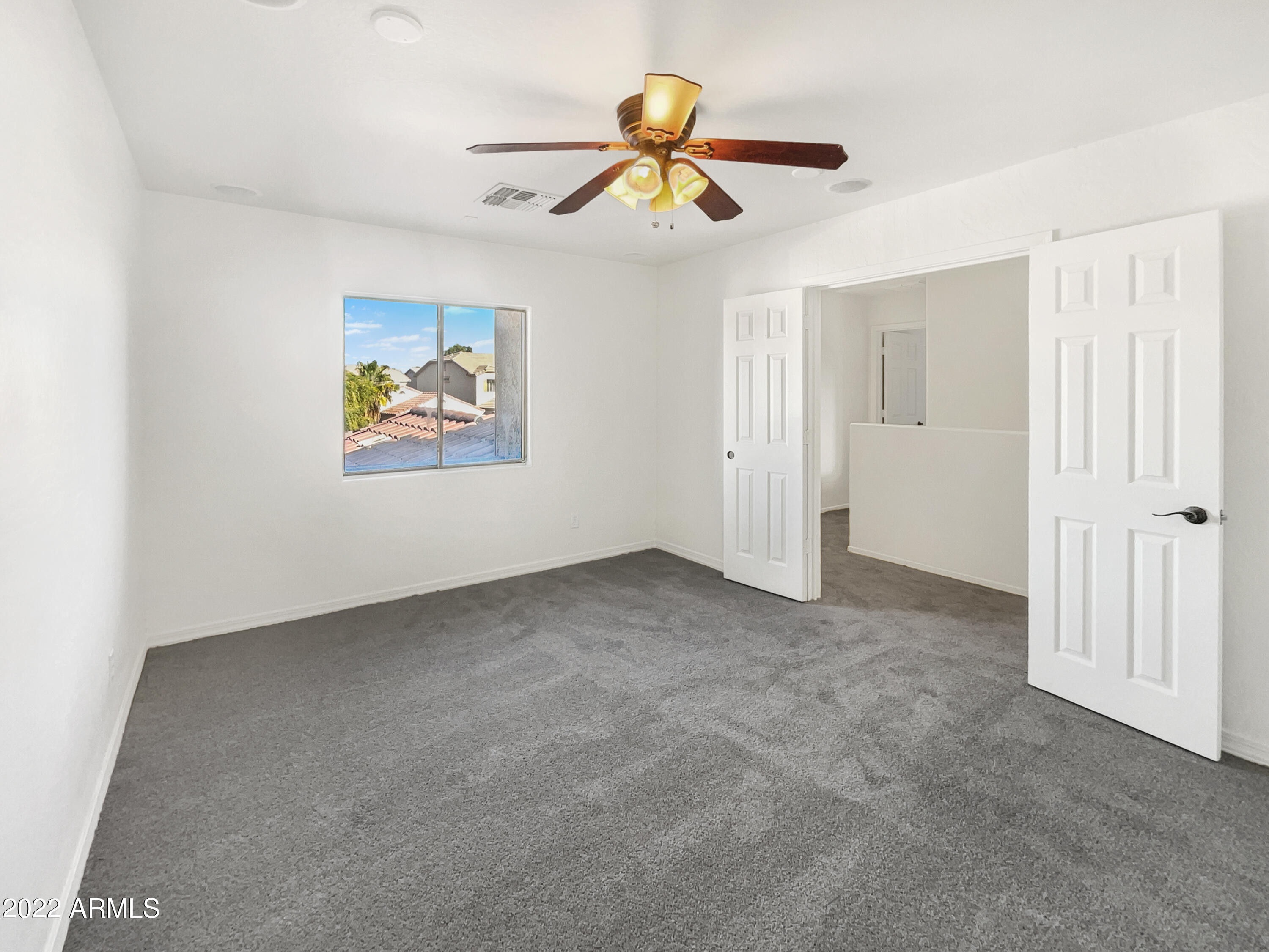 44011 West Cowpath Road Maricopa, AZ 85138 - Photo 13 of 18 a view of an empty room with a window