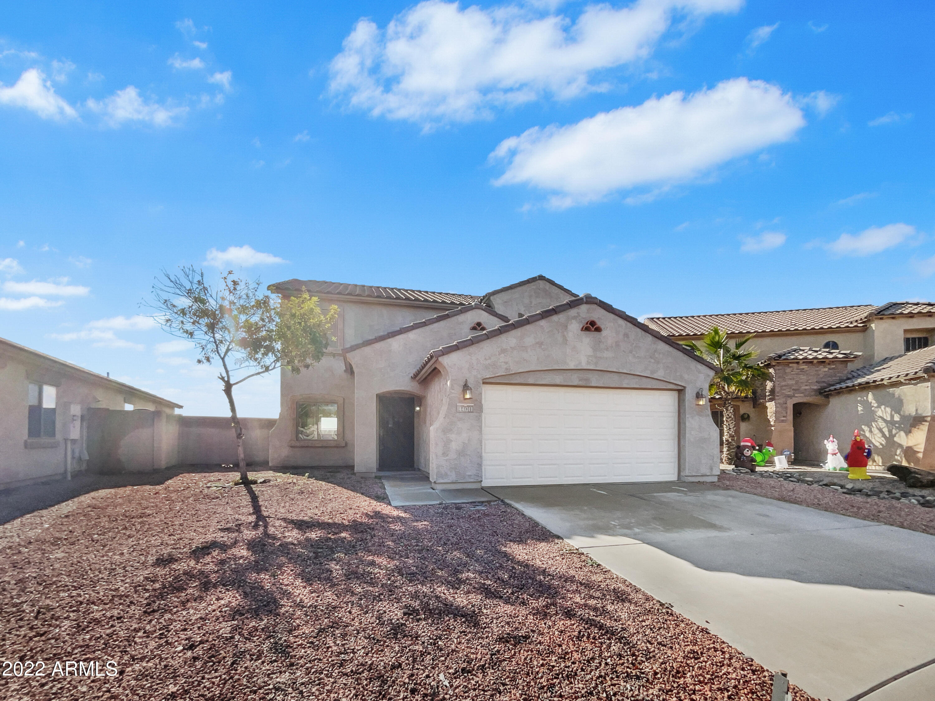 44011 West Cowpath Road Maricopa, AZ 85138 - Photo 4 of 18 a view of a white house with a yard