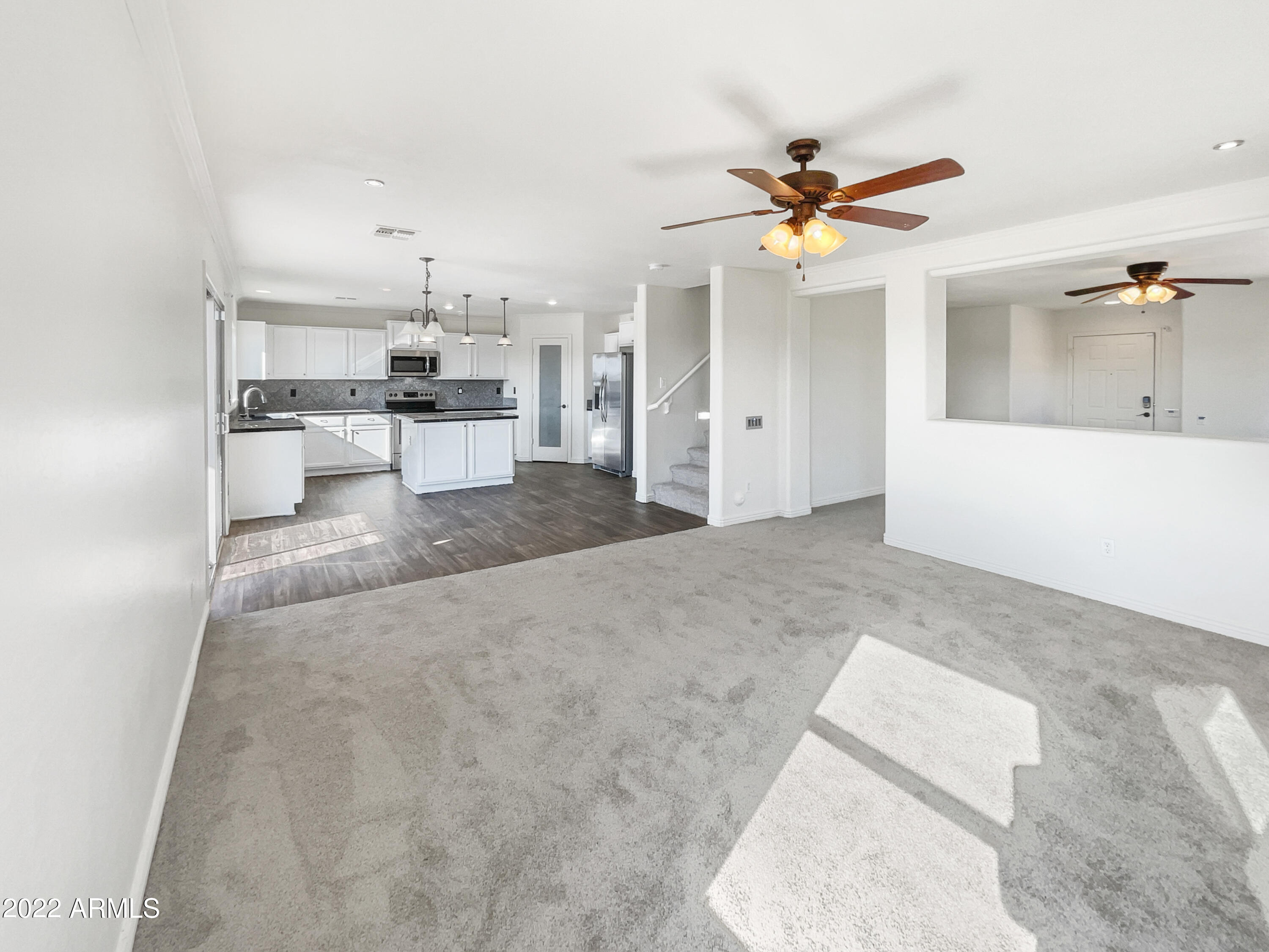 44011 West Cowpath Road Maricopa, AZ 85138 - Photo 6 of 18 a living room with kitchen view and a ceiling fan