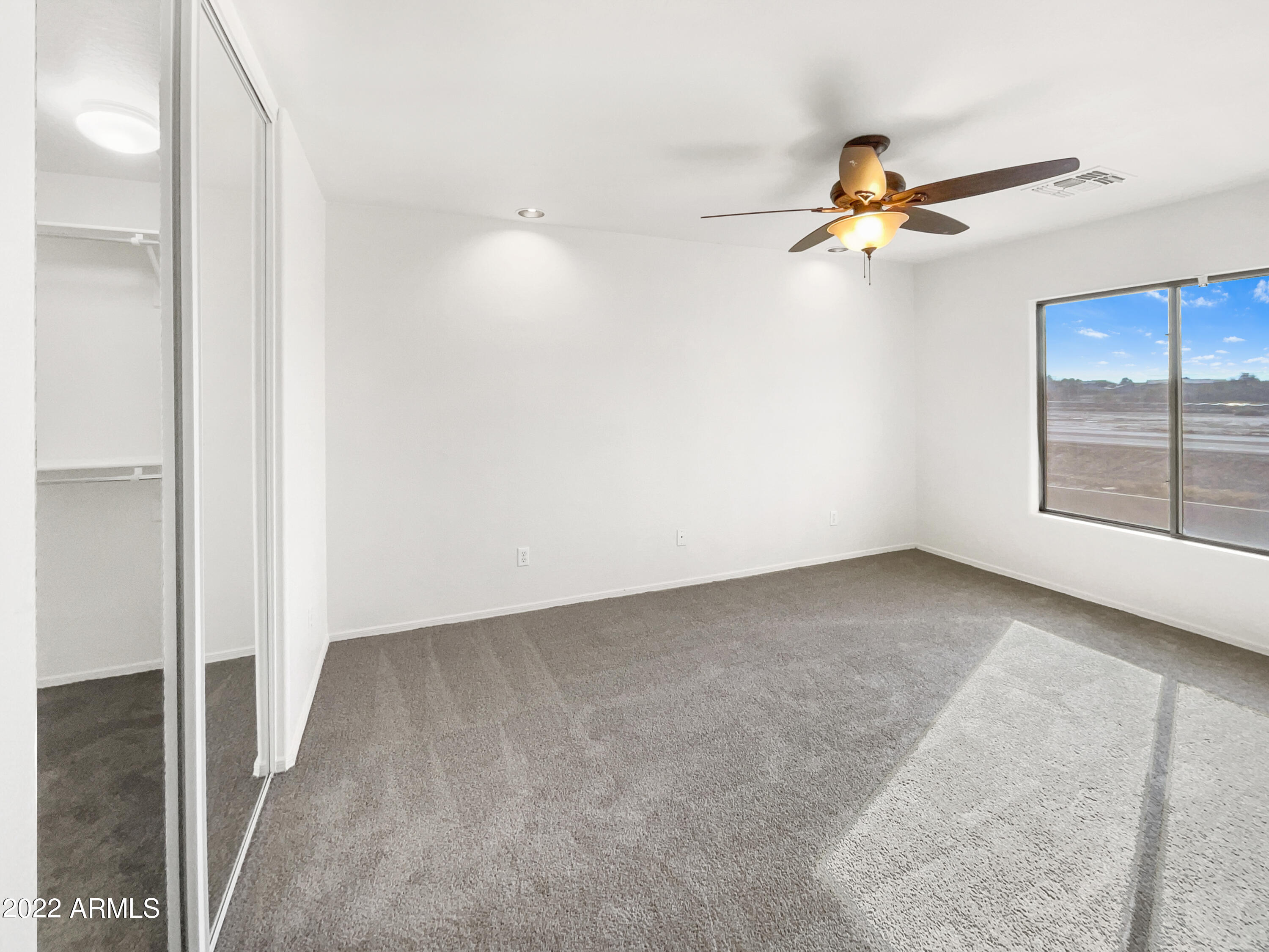 44011 West Cowpath Road Maricopa, AZ 85138 - Photo 8 of 18 wooden floor in an empty room with a window