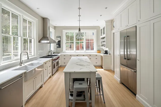 a kitchen with stainless steel appliances granite countertop a sink and wooden cabinets