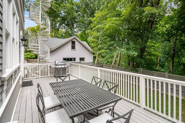 a view of a wooden chairs and table on the deck