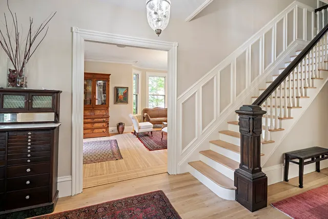 a view of entryway livingroom and hall with wooden floor