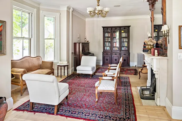 a living room with furniture a rug and a window