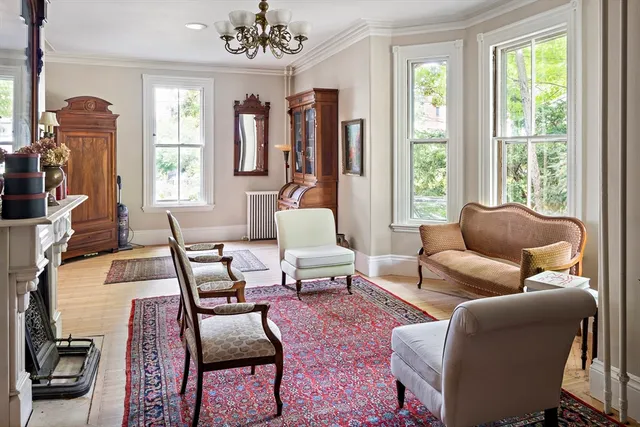 a living room with furniture and a chandelier