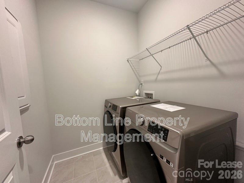 5915 Ardrey Kell Road Charlotte, NC 28105 - Photo 17 of 19 a utility room with dryer and washer