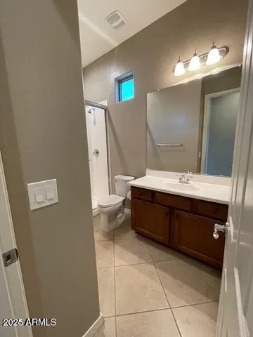 a bathroom with a double vanity sink a mirror and a toilet