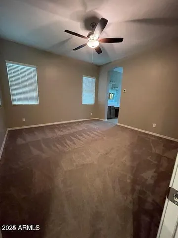a view of an empty room with a ceiling fan