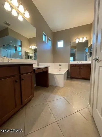 a large bathroom with a large tub and sink