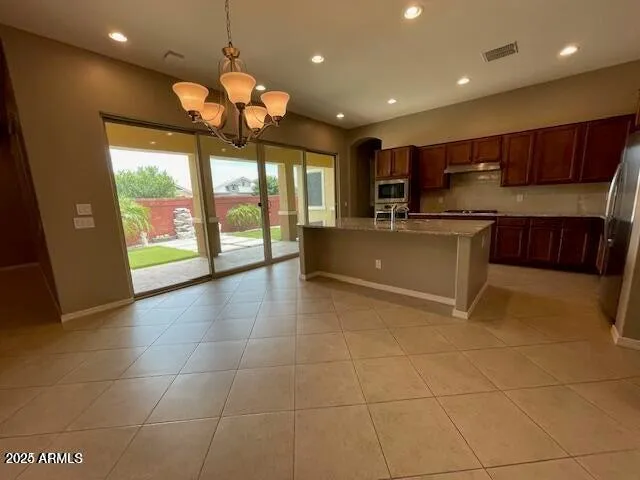 a kitchen with stainless steel appliances granite countertop a sink and a stove