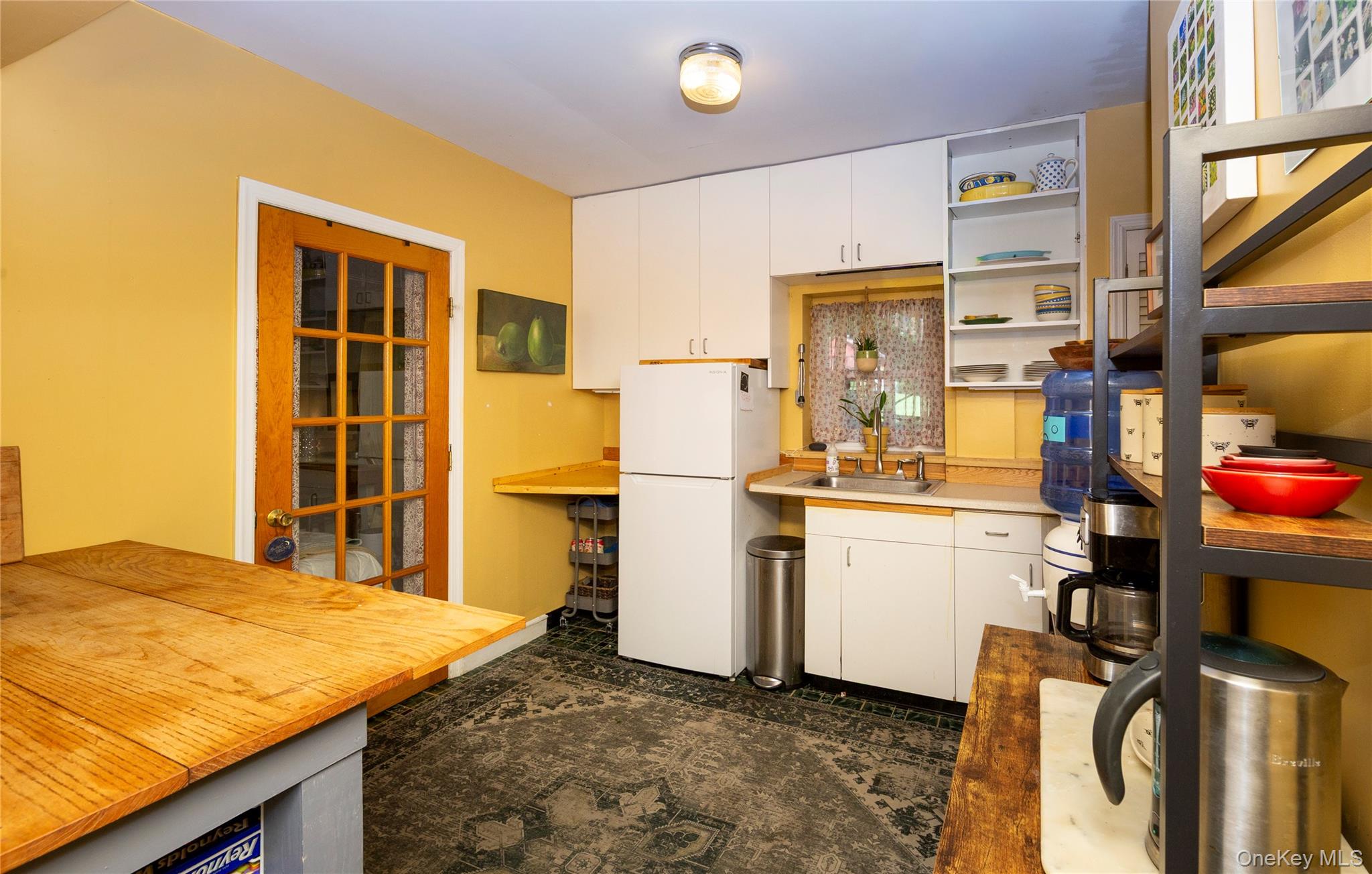 32 Cobb Road Brewster, NY 10509 - Photo 37 of 49 a kitchen with a refrigerator and white cabinets