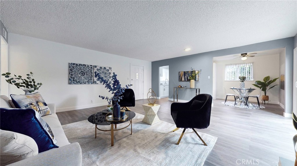 a living room with furniture and a potted plant