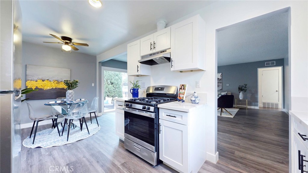 10915 Eldora Avenue Sunland, CA 91040 - Photo 13 of 39 a kitchen with stainless steel appliances granite countertop a stove and a wooden floors