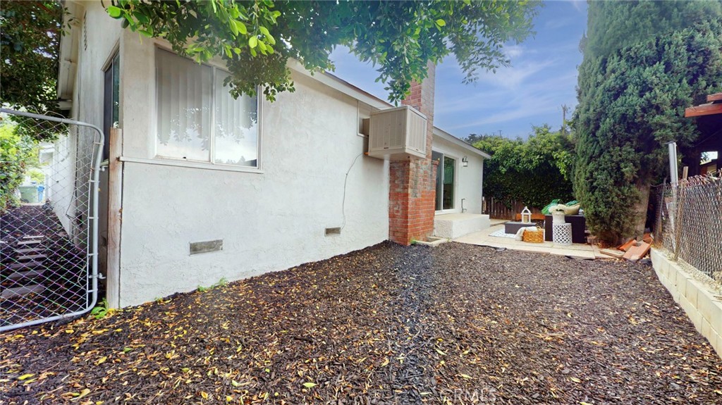 10915 Eldora Avenue Sunland, CA 91040 - Photo 37 of 39 a backyard of a house with wooden fence and trees