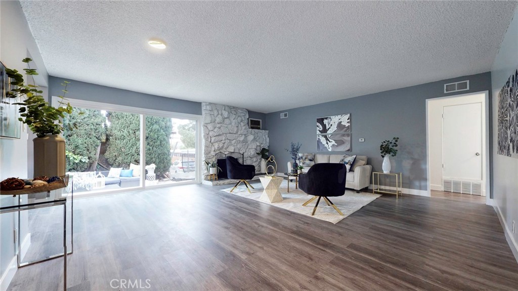 10915 Eldora Avenue Sunland, CA 91040 - Photo 5 of 39 a living room with furniture large window and a fireplace