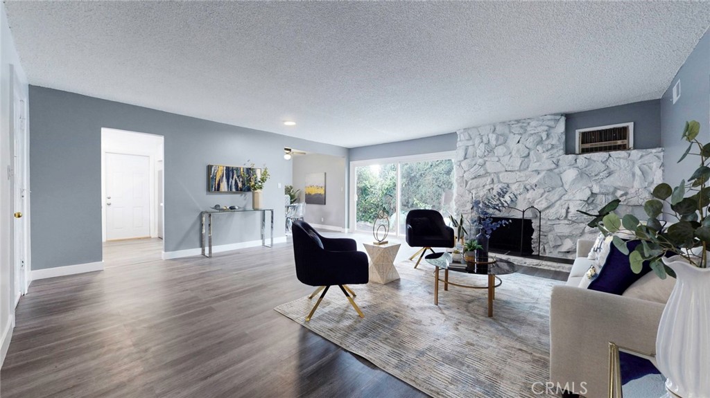 10915 Eldora Avenue Sunland, CA 91040 - Photo 9 of 39 a living room with furniture a fireplace and a flat screen tv