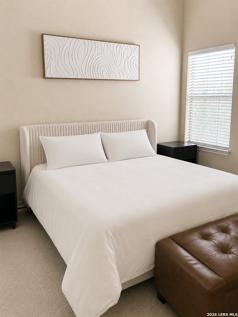 6160 Eckhert Road, Unit 804 San Antonio, TX 78240 - Photo 18 of 38 a bedroom with a bed and a couch
