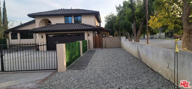 a front view of a house with wooden fence